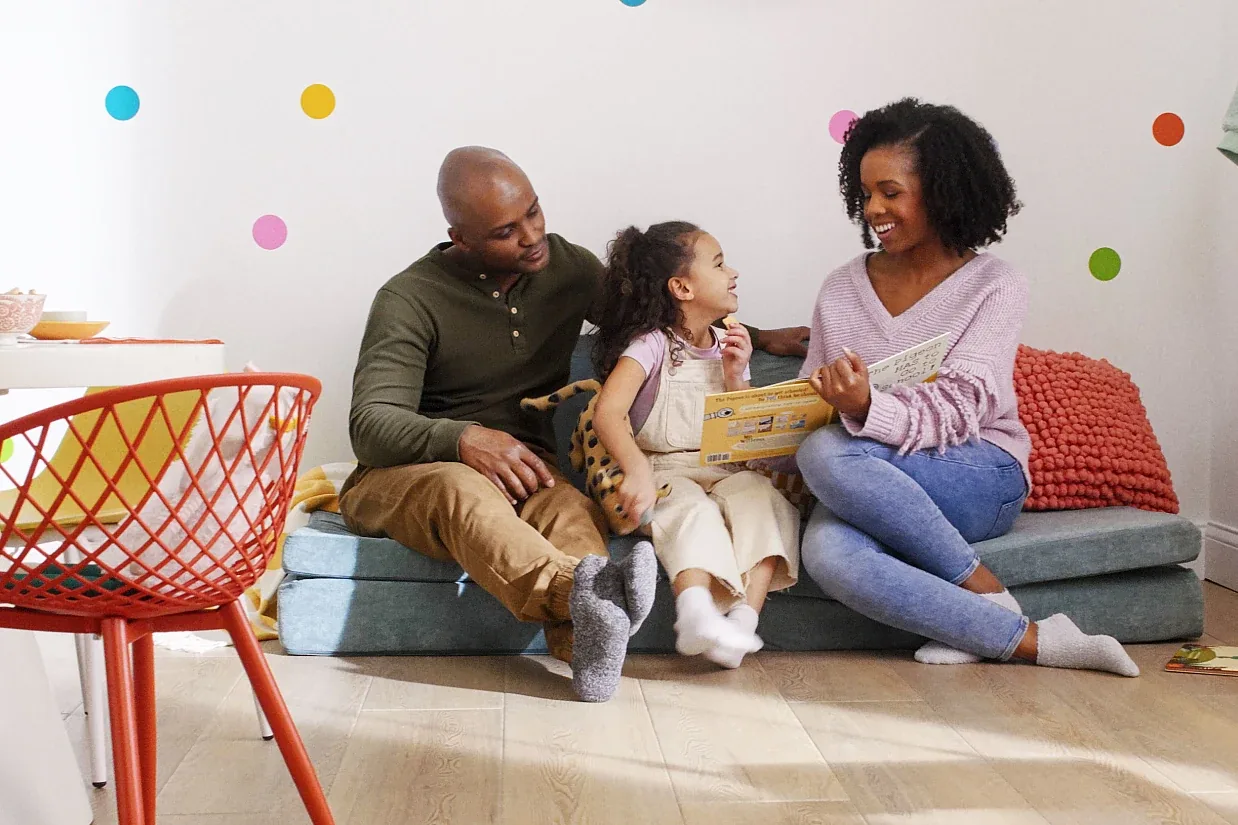 Family seated together above light wood-look COREtec flooring